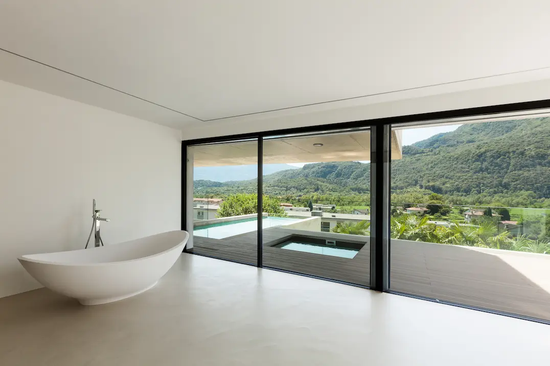 Bathroom with exterior views and microcement on the floor